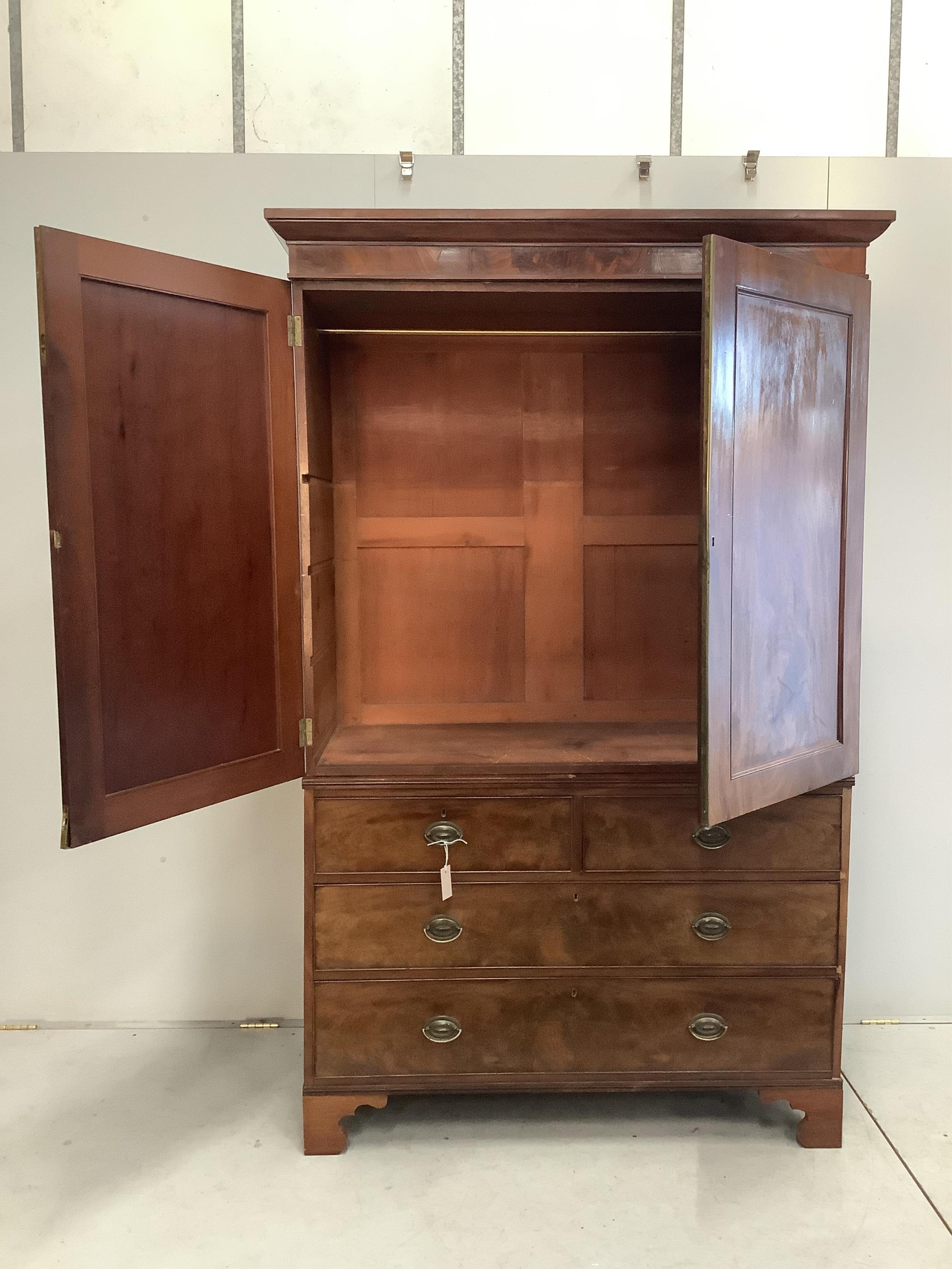 A George III mahogany linen press converted to a hanging wardrobe, width 130cm, depth 58cm, height 206cm. Condition - fair